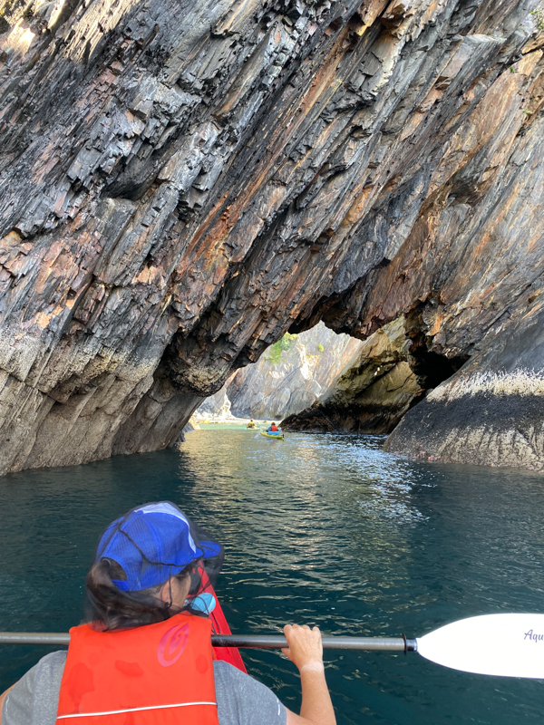 youth educational adventures group kayaking through calm waters in alaska